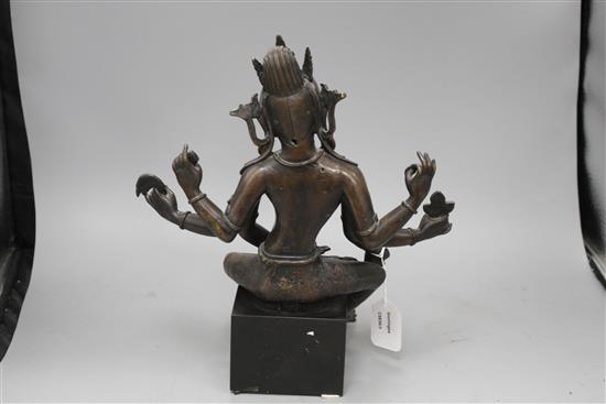 A Sino-Tibetan bronze figure of a seated female deity, on associated marble plinth, height 35cm